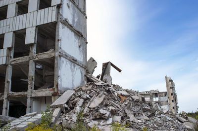 Low angle view of abandoned building against sky