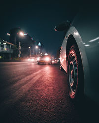 Car on illuminated street at night
