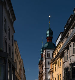 Low angle view of buildings against blue sky