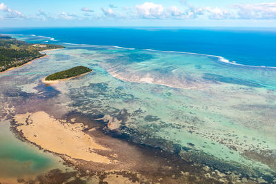 Turquoise ocean, beach and coral reefs from high angle view in le morne beach, mauritius