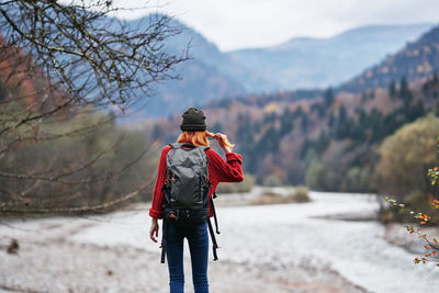 Rear view of person standing on snow covered mountain