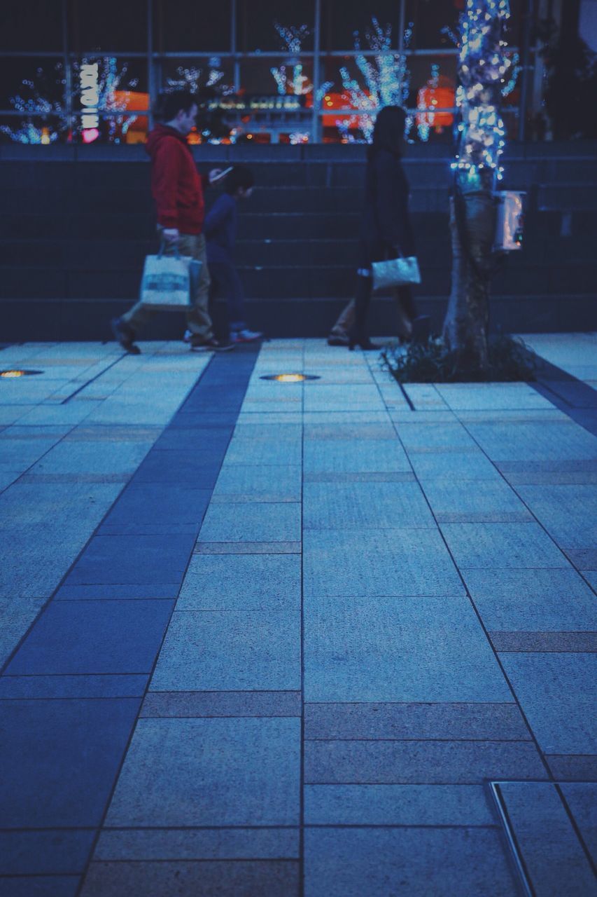 WOMAN STANDING AT NIGHT