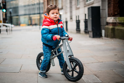Boy with bicycle in city