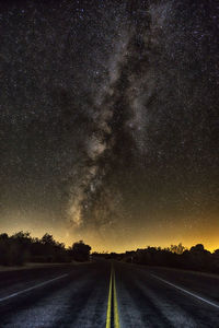 Road against sky at night