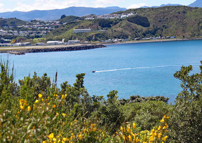 Scenic view of sea and mountains against sky