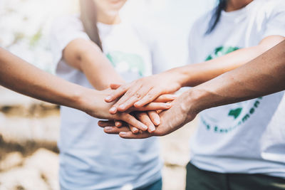 Midsection of couple holding hands