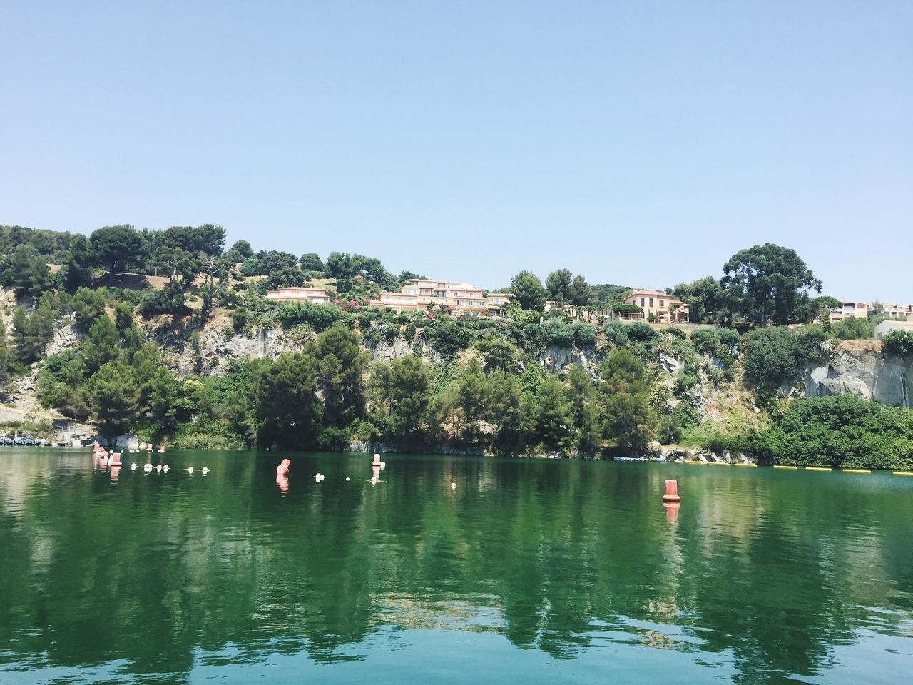 water, clear sky, waterfront, tree, nautical vessel, lake, copy space, tranquil scene, boat, tranquility, transportation, scenics, nature, reflection, beauty in nature, mountain, river, mode of transport, leisure activity