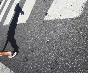 Low section of man standing on street