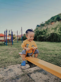 Boy sitting on field