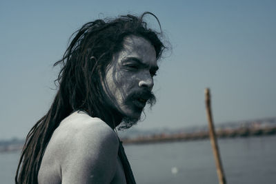 Portrait of man against sea against clear sky