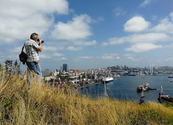 Photographer making a great shot of bay from the mountain