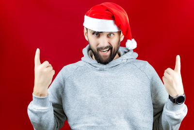 Portrait of smiling mid adult man against red background