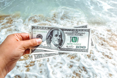 Close-up of hand holding paper currency