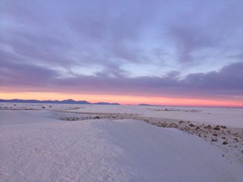 Scenic view of beach against sky during sunset