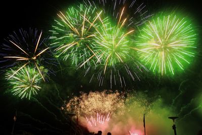 Low angle view of firework display at night