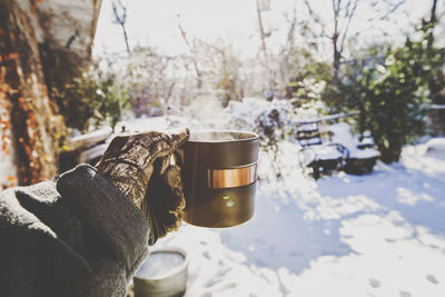 Close-up of hand holding coffee cup