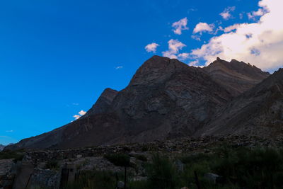 Low angle view of mountain against blue sky