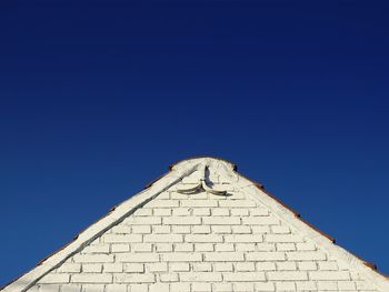 High section of building against clear blue sky