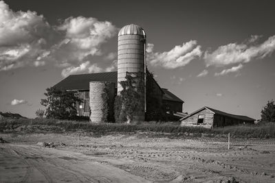 Barn on field against sky