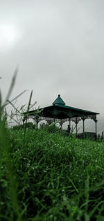 Built structure on field against sky