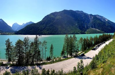 Scenic view of lake and mountains against clear sky