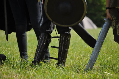 Men wearing costume while standing on grassy land