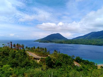 Scenic view of lake and mountains against sky