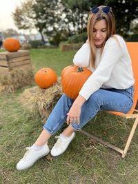 Portrait of young woman sitting on grass