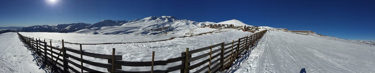 Scenic view of snowcapped mountains against clear sky