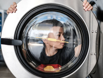 Portrait of a young man at the laundrette