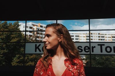 Young woman with text against sky