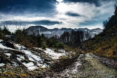 Scenic view of mountains against cloudy sky