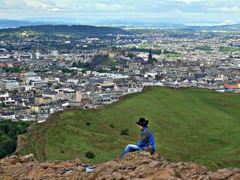 High angle view of man and woman sitting against buildings