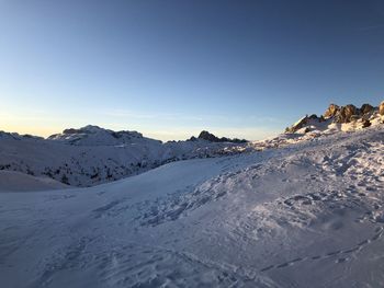 Scenic view of snowcapped mountains against clear sky