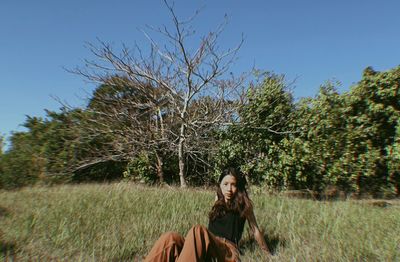 Portrait of woman on field against sky