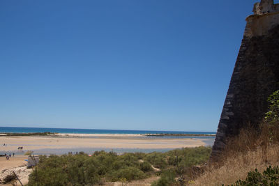 View of beach against blue sky