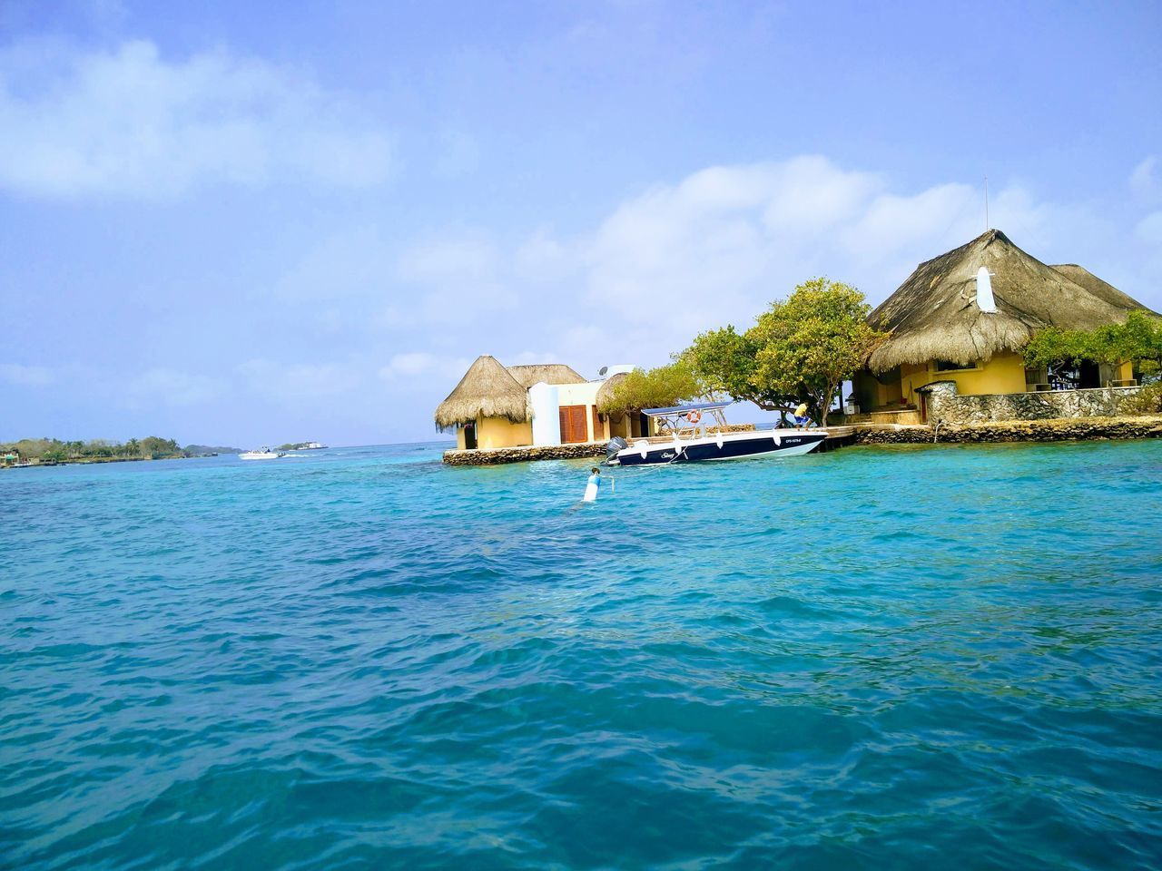 water, thatched roof, scenics, built structure, sky, waterfront, hut, architecture, sea, beauty in nature, house, tranquility, outdoors, tranquil scene, stilt house, nature, building exterior, idyllic, day, no people, blue, luxury, holiday villa