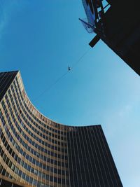 Low angle view of skyscraper against clear blue sky