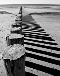 Wooden posts on beach