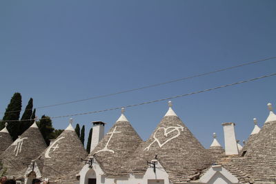 Low angle view of buildings against clear blue sky