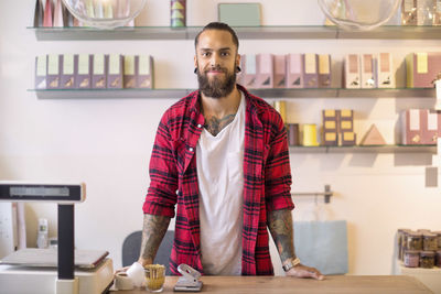 Portrait of smiling owner in candy store