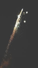 Low angle view of firework display at night