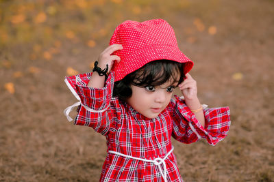 Portrait of cute girl standing on field