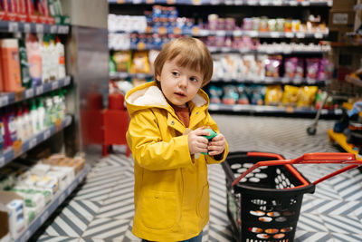 Portrait of cute boy standing in supermarket