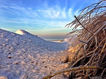 Scenic view of snow covered land against sky