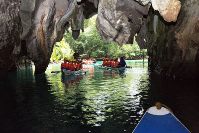 Group of people on rock by river