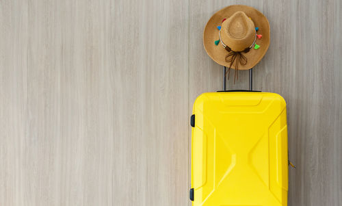 Directly above shot of yellow hat on wall