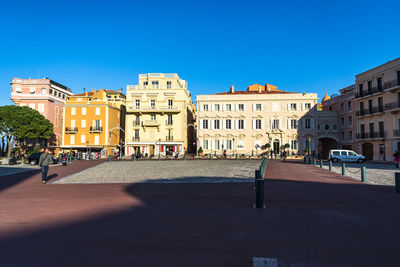Buildings in city against blue sky