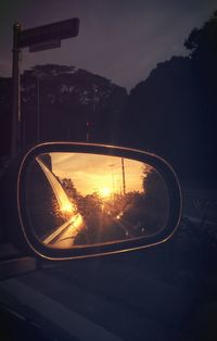 View of sunset through side-view mirror