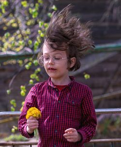 Portrait of cute girl holding outdoors